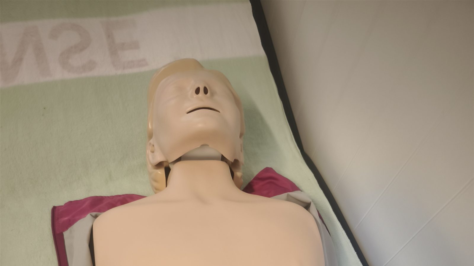 CPR manikin on a mat, ready for a CPR training session.