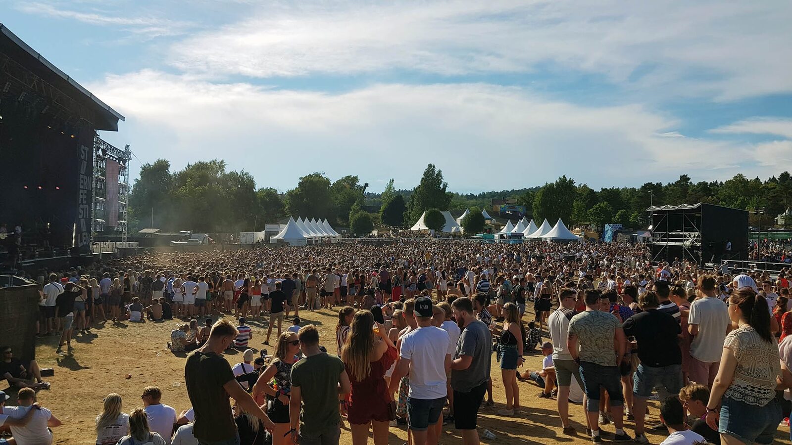 The festival area at Stavernfestivalen seen from the stage, with the audience, tents and the first aid post in the background.